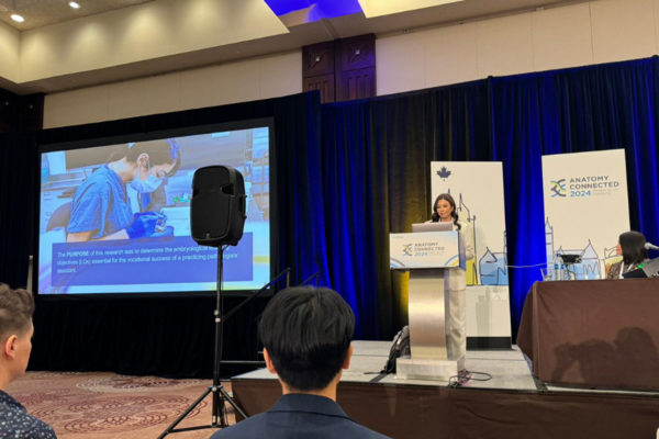 A woman standing at a podium speaking