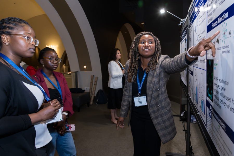 someone pointing at a poster while others listen