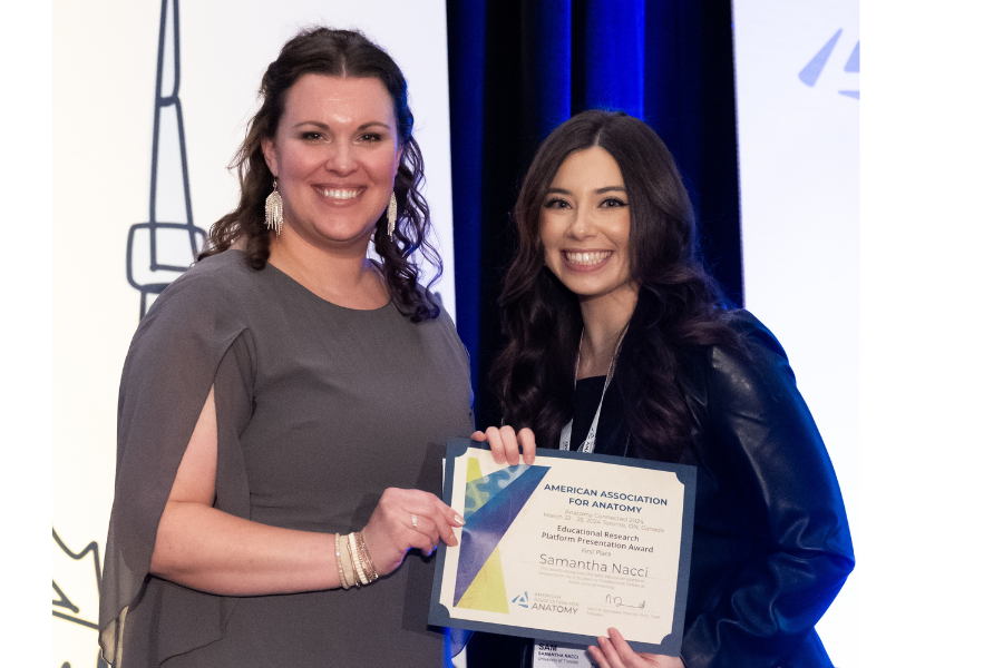 Two women smiling and holding a certificate